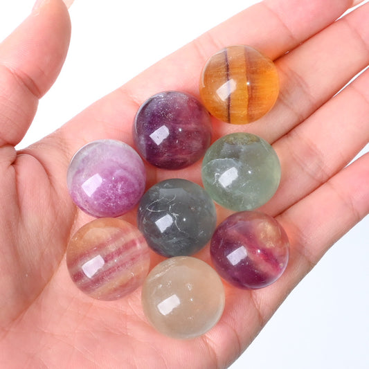 A polished 20mm natural Rainbow Fluorite crystal sphere featuring unique green and purple banding. Perfect for home décor, office styling, crystal collections, or meaningful gifting.