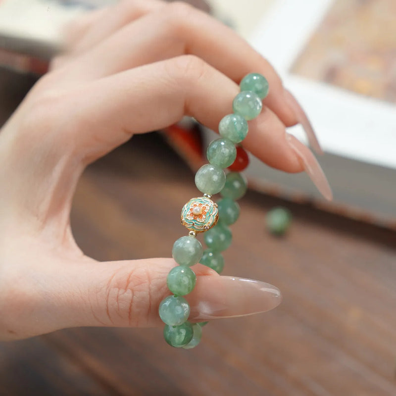 WhisperCrystal™ Natural Green Aventurine and Red Agate Bracelet featuring polished 8mm green aventurine beads, a vibrant red agate accent, and an elegant enamel-inspired charm in a Dunhuang-inspired color palette.