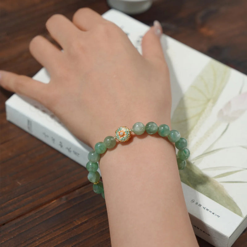 WhisperCrystal™ Natural Green Aventurine and Red Agate Bracelet featuring polished 8mm green aventurine beads, a vibrant red agate accent, and an elegant enamel-inspired charm in a Dunhuang-inspired color palette.